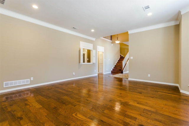 spare room featuring crown molding and dark hardwood / wood-style floors