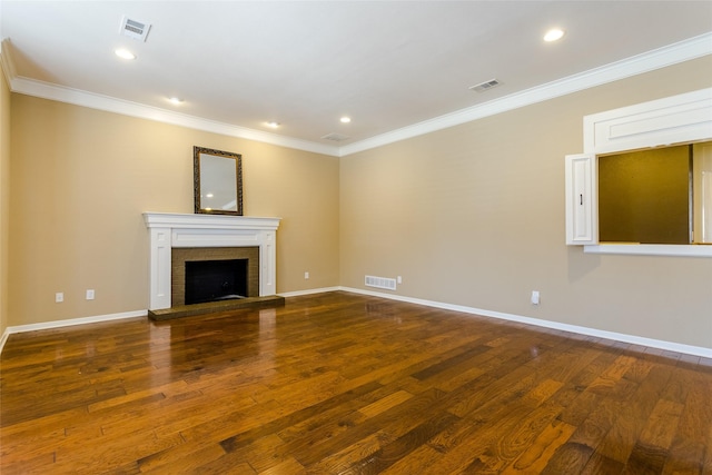 unfurnished living room with crown molding, a fireplace, and dark hardwood / wood-style floors