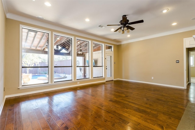 empty room featuring dark hardwood / wood-style flooring, ornamental molding, and ceiling fan