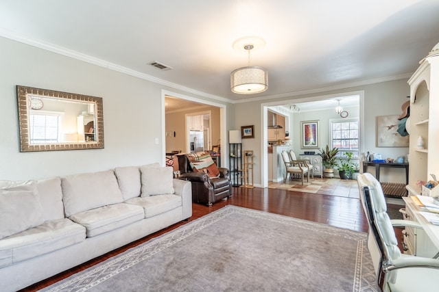 living room featuring dark wood-type flooring and ornamental molding