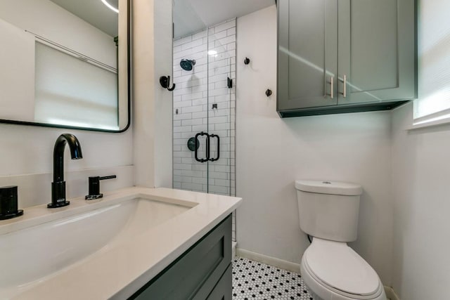 bathroom featuring vanity, toilet, and a shower with shower door