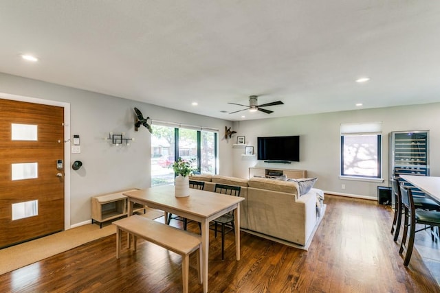 living room with dark wood-type flooring and ceiling fan