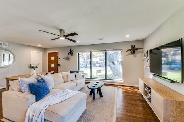 living room featuring dark hardwood / wood-style floors and ceiling fan