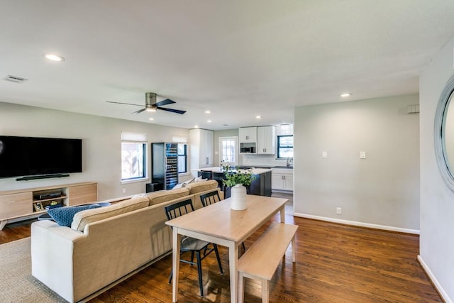 living room with ceiling fan, sink, and dark hardwood / wood-style flooring