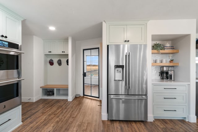 1252 Harmony Cir, Weatherford, TX 76087 - kitchen featuring stainless steel appliances, white cabinets, dark wood-type flooring, and recessed lighting