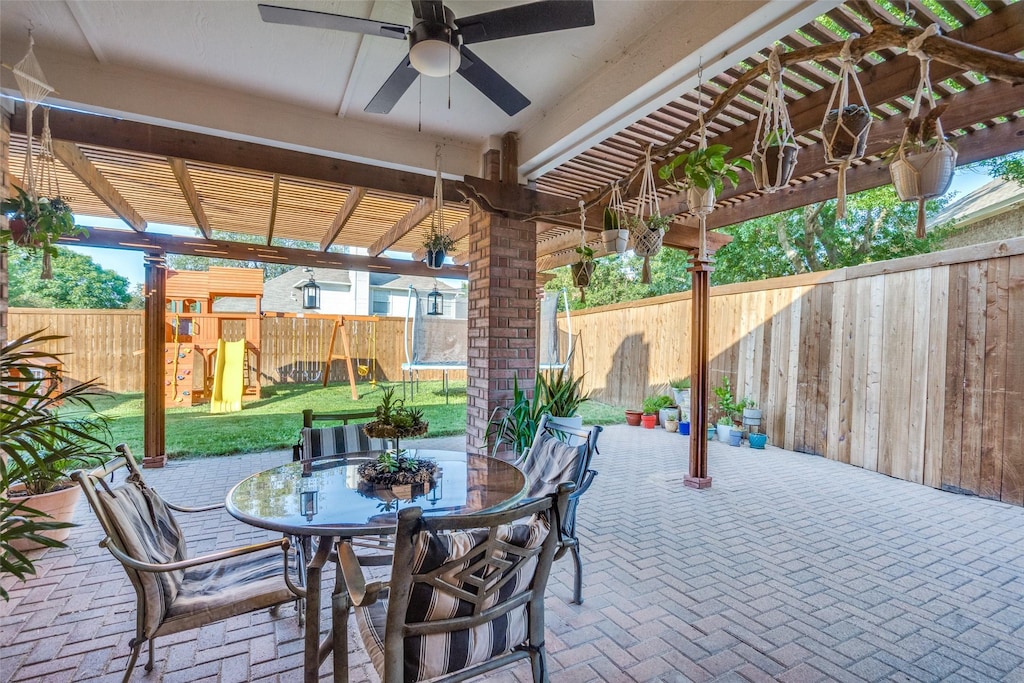 view of patio featuring ceiling fan, a pergola, a playground, and a trampoline