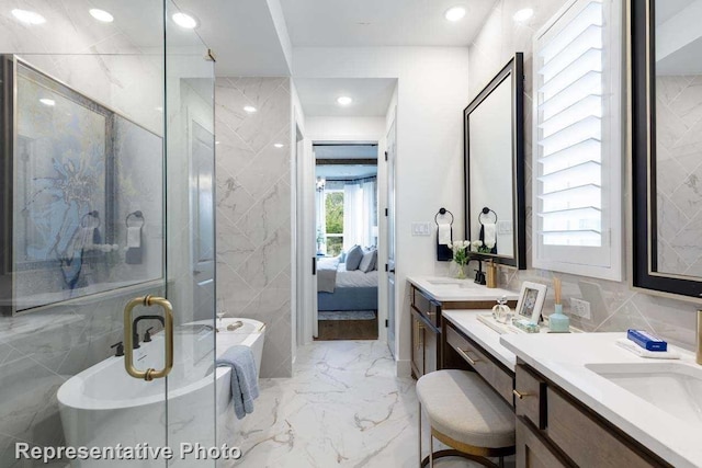 bathroom featuring tile walls, vanity, and shower with separate bathtub