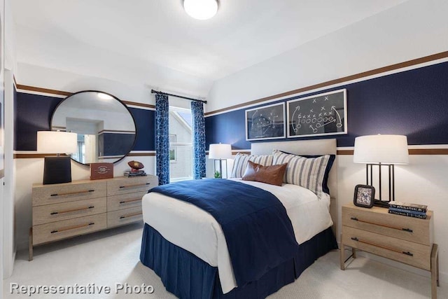 carpeted bedroom featuring lofted ceiling