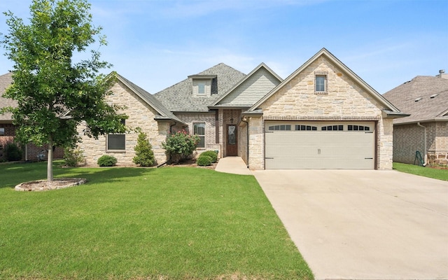 craftsman house featuring a garage, driveway, a shingled roof, stone siding, and a front yard