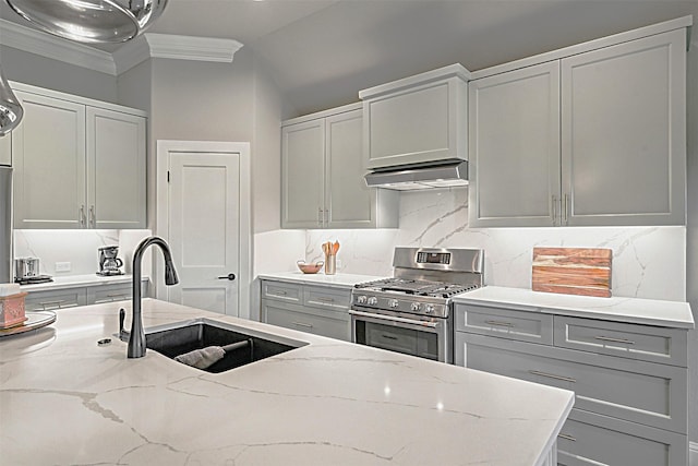 kitchen with sink, stainless steel range with gas stovetop, ornamental molding, light stone countertops, and decorative backsplash