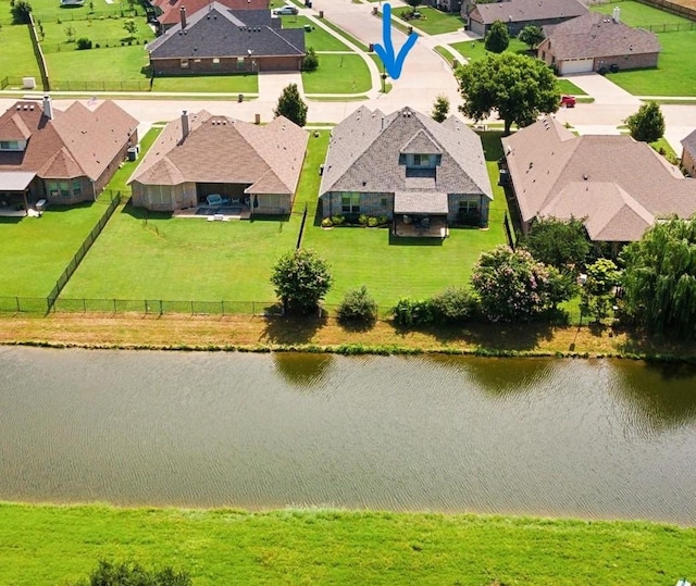 birds eye view of property with a water view and a residential view