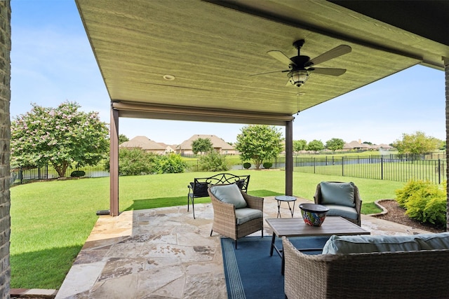 view of patio featuring a water view and ceiling fan