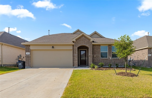 ranch-style home with a garage and a front yard