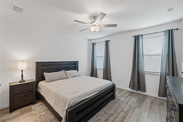 bedroom featuring multiple windows, ceiling fan, and light hardwood / wood-style floors