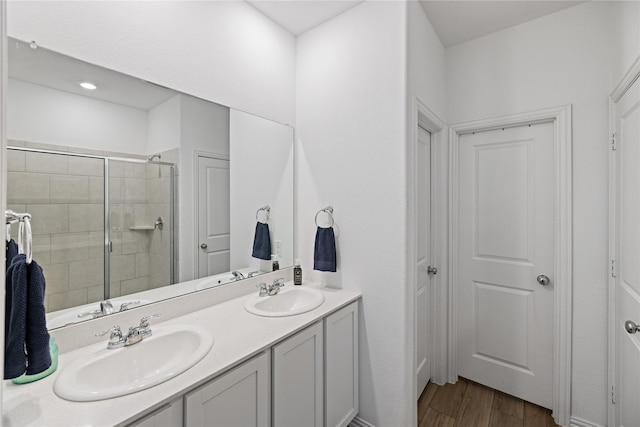 bathroom featuring vanity, hardwood / wood-style floors, and walk in shower