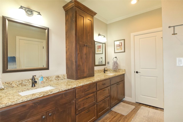 bathroom featuring wood-type flooring, vanity, and crown molding