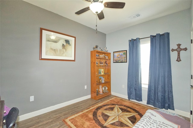 living area with hardwood / wood-style flooring and ceiling fan