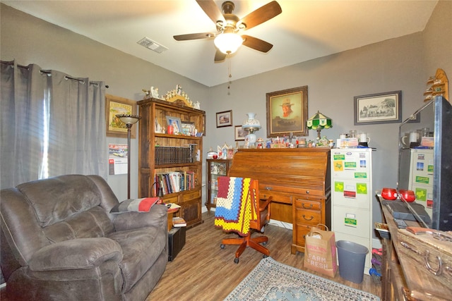 sitting room with wood-type flooring and ceiling fan