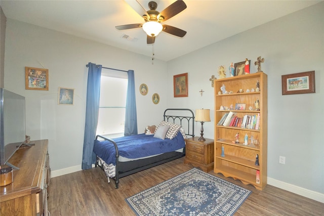 bedroom featuring ceiling fan and dark hardwood / wood-style floors