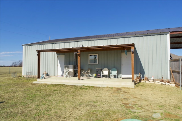 back of property featuring a patio and a yard