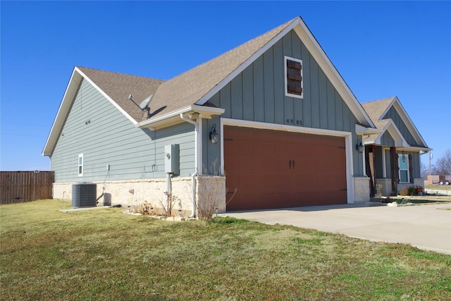 craftsman-style home with a garage, central AC, and a front lawn