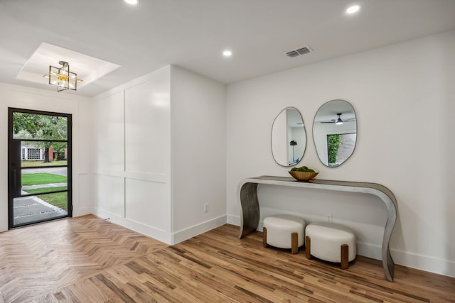 interior space with a chandelier and light parquet floors