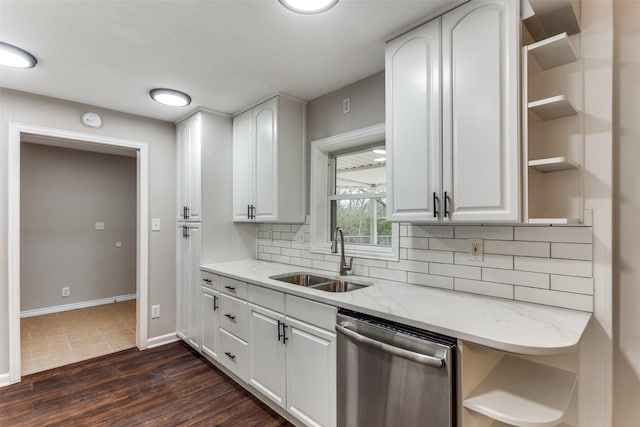 kitchen with sink, white cabinetry, dishwasher, light stone countertops, and backsplash