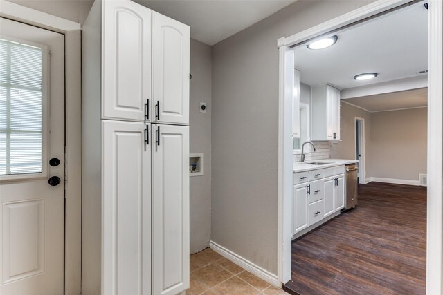 laundry room featuring hookup for a washing machine, sink, dark tile patterned flooring, and electric dryer hookup