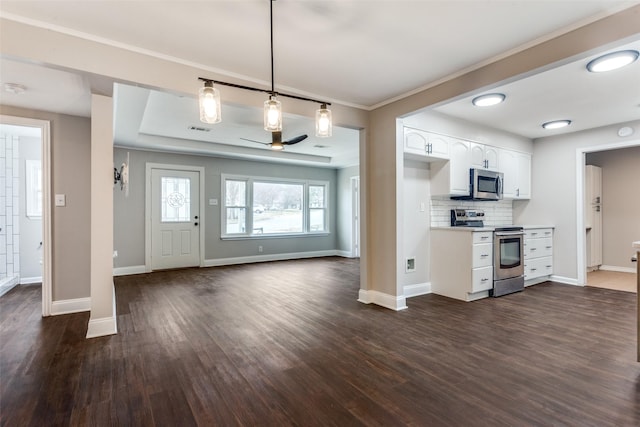 kitchen with appliances with stainless steel finishes, decorative light fixtures, tasteful backsplash, white cabinetry, and dark wood-type flooring