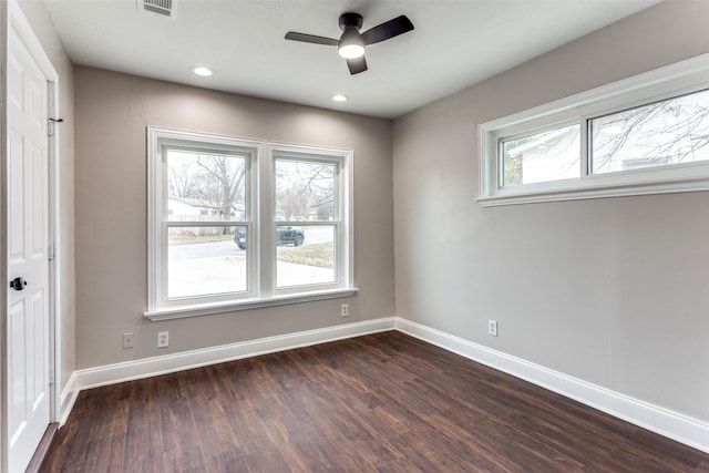 spare room featuring dark wood-type flooring and ceiling fan