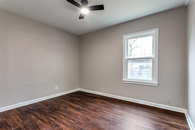 empty room with ceiling fan and dark hardwood / wood-style floors