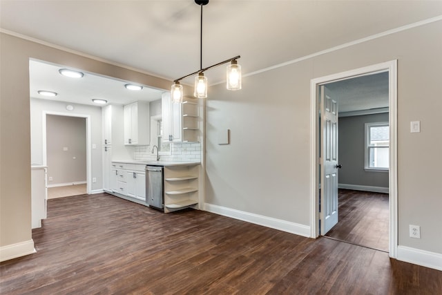 kitchen featuring decorative light fixtures, tasteful backsplash, white cabinetry, dark hardwood / wood-style flooring, and crown molding