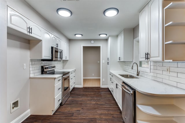 kitchen with appliances with stainless steel finishes, sink, white cabinets, and dark hardwood / wood-style flooring