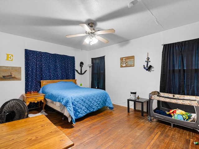 bedroom featuring hardwood / wood-style flooring and ceiling fan