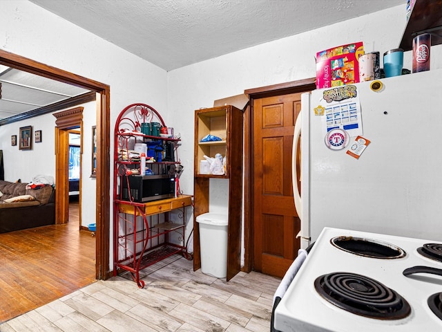 kitchen with white appliances and a textured ceiling