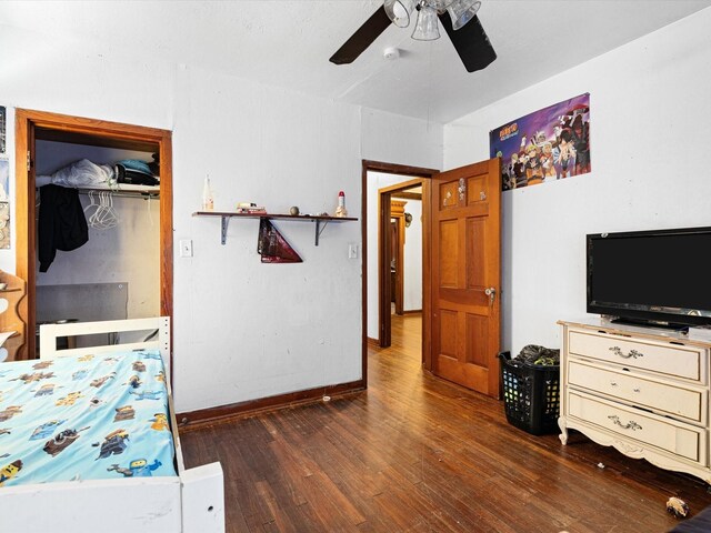 bedroom with ceiling fan, dark hardwood / wood-style floors, and a closet