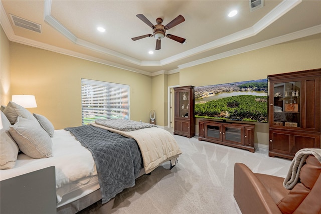 bedroom with a raised ceiling, ornamental molding, light colored carpet, and ceiling fan