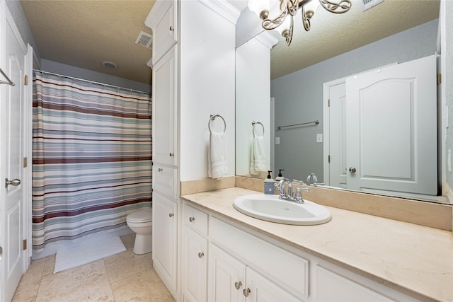 bathroom with vanity, a notable chandelier, a textured ceiling, toilet, and walk in shower