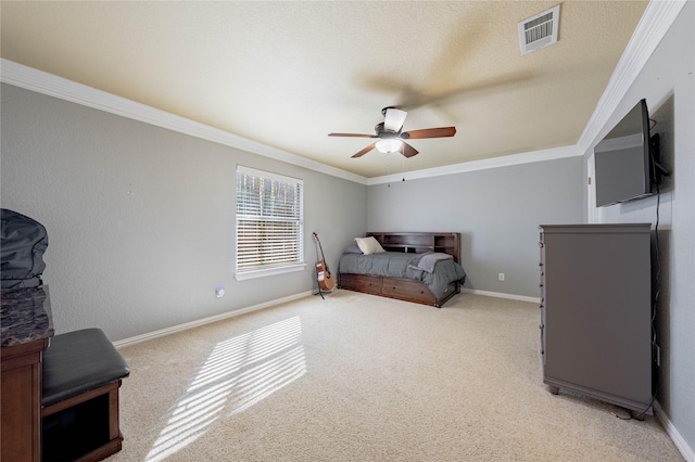 bedroom with ceiling fan, light colored carpet, ornamental molding, and a textured ceiling