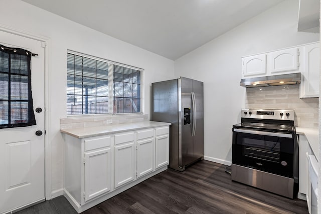 kitchen featuring dark wood-type flooring, appliances with stainless steel finishes, white cabinetry, tasteful backsplash, and vaulted ceiling