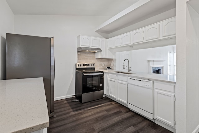 kitchen with sink, dark hardwood / wood-style floors, stainless steel appliances, decorative backsplash, and white cabinets