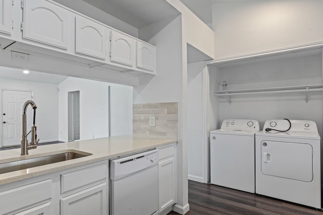 washroom with dark hardwood / wood-style floors, sink, and washer and dryer