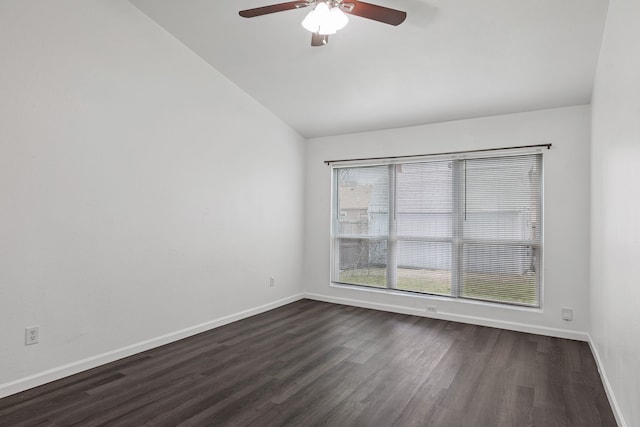 empty room featuring vaulted ceiling, dark wood-type flooring, and ceiling fan