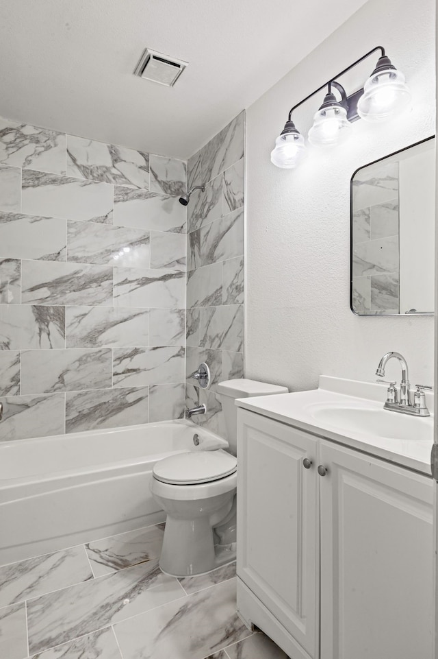 full bathroom with vanity, toilet, and tiled shower / bath combo