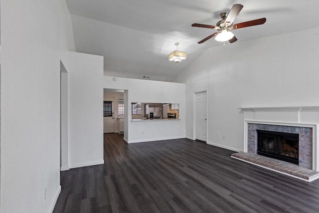 unfurnished living room featuring dark wood-type flooring, ceiling fan, high vaulted ceiling, and a brick fireplace