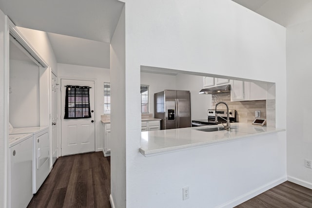 kitchen with stainless steel appliances, dark hardwood / wood-style floors, separate washer and dryer, and white cabinets