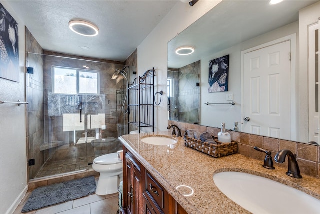 bathroom featuring an enclosed shower, vanity, tile patterned floors, and toilet