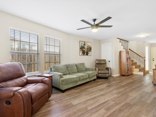 living room with ceiling fan and light hardwood / wood-style floors