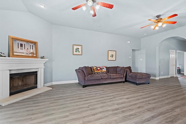 living room featuring vaulted ceiling, ceiling fan, and light hardwood / wood-style floors