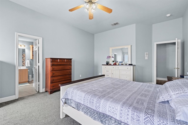 bedroom with light carpet, connected bathroom, and ceiling fan